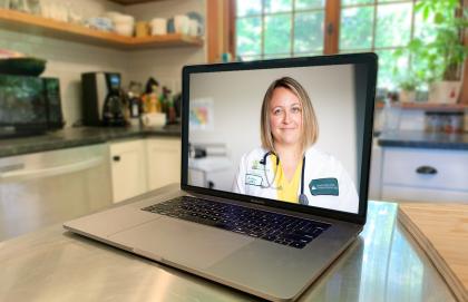 Doctor seeing patient through video conference on computer