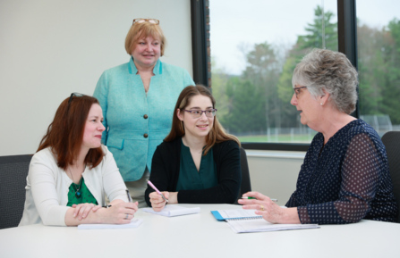 Family Medicine Residency staff and resident having a discussion at a table