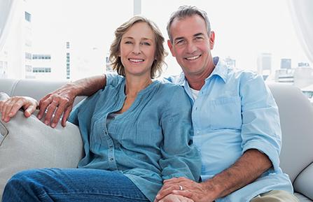 Midlife couple sitting on a couch - advance care directive story.