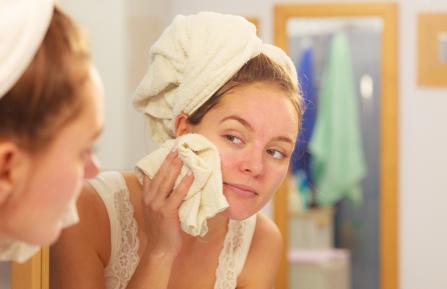 Woman moisturizing dry skin