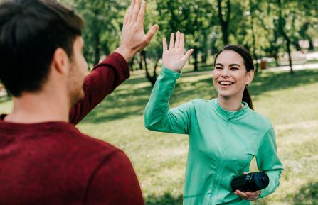 People high-fiving outside