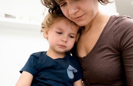 A mother holding a sick child