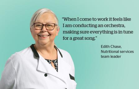 "When I come to work it feels like I am conducting an orchestra, making sure everything is in tune for a great song." Older white woman in chef's coat smiles at camera