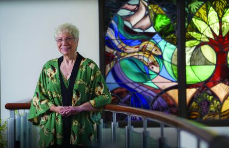 Pauline Johansen stands next to the chapel window at Cheshire Medical Center