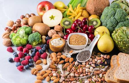 A beautiful array of fiber-filled foods such as nuts, beans, berries, vegetables, fruits