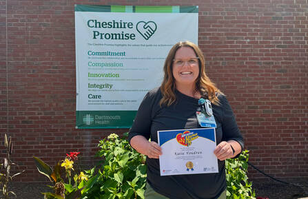 Katelyn Voudren, RN, poses for a photo with her award outside of Cheshire Medical Center.