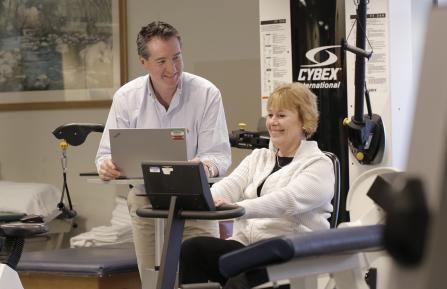 Outpatient physical rehab staff member with patient