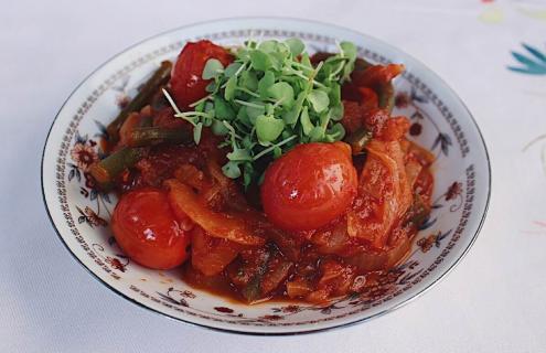 Garlic scape friggione, or braised garlic scapes with onions and cherry tomatoes