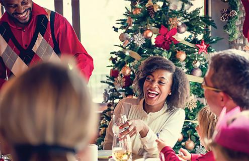 Group of people laughing together at a holiday gathering