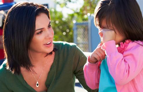 Woman talking to an upset child