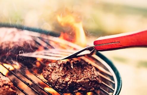 grilling meat on a barbeque