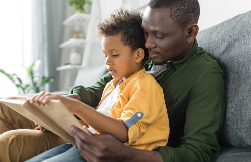 Man reading with child