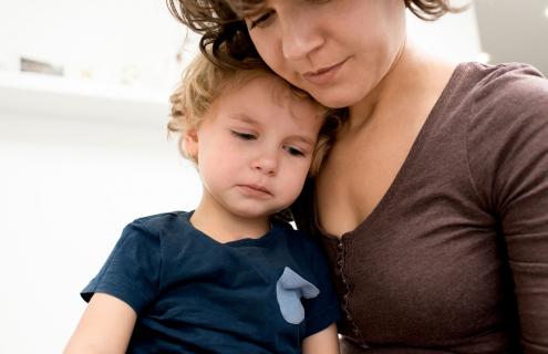 A mother holding a sick child