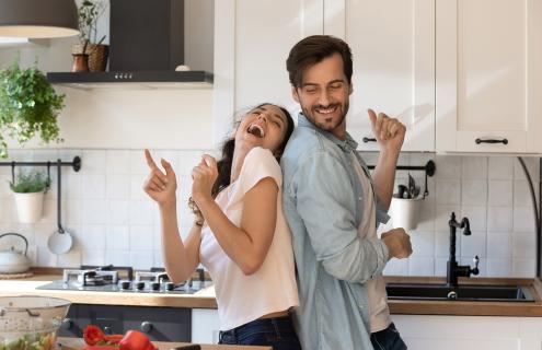 Woman and man dancing in a kitchen