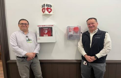 m left, John Letendre, continuum of care facilitator for Cheshire Medical Center’s Center for Population Health, and Steve Perrin, safety coordinator for Cheshire County, stand beside a NaloxBox opioid rescue kit.