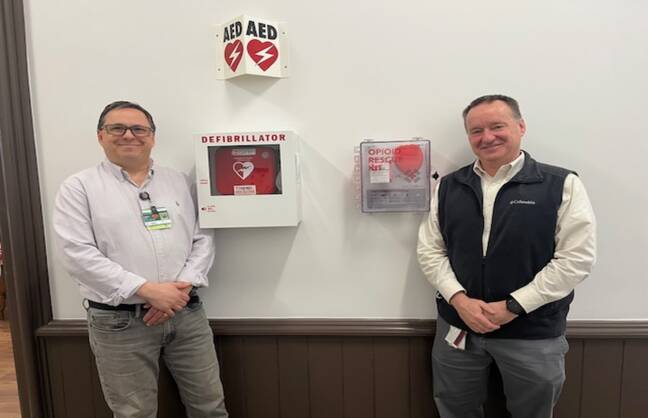 m left, John Letendre, continuum of care facilitator for Cheshire Medical Center’s Center for Population Health, and Steve Perrin, safety coordinator for Cheshire County, stand beside a NaloxBox opioid rescue kit.