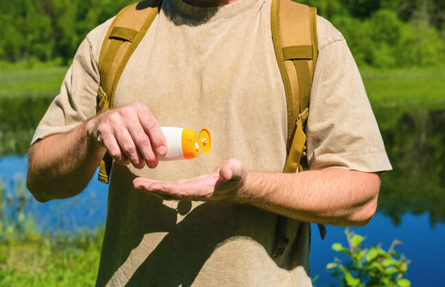 A person applying sunscreen