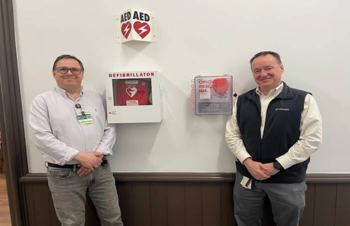 m left, John Letendre, continuum of care facilitator for Cheshire Medical Center’s Center for Population Health, and Steve Perrin, safety coordinator for Cheshire County, stand beside a NaloxBox opioid rescue kit.