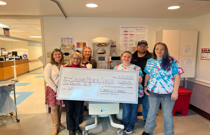 Cheshire Medical Center staff, Jen and Dan Clayman and a family friend stand with donation check