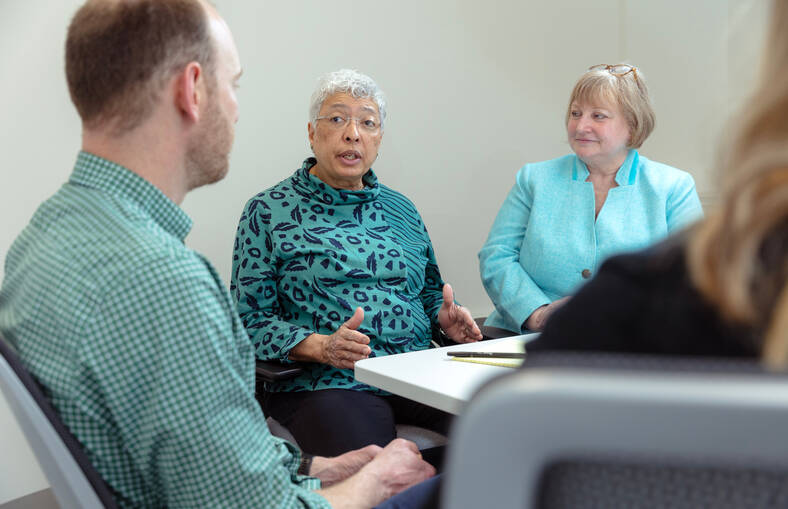 Karl Dietrich, Cheri Holmes and Cathy Schuman in a discussion around a table